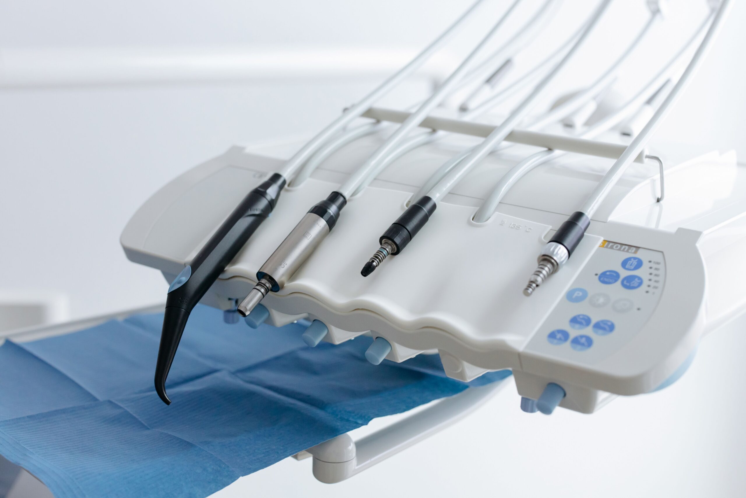 Close-up of dental equipment with handpieces, showcasing modern dental care tools in a clinic.